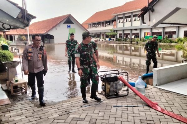 Petugas gabungan saat melakukan pemompaan genangan air di lokasi banjir